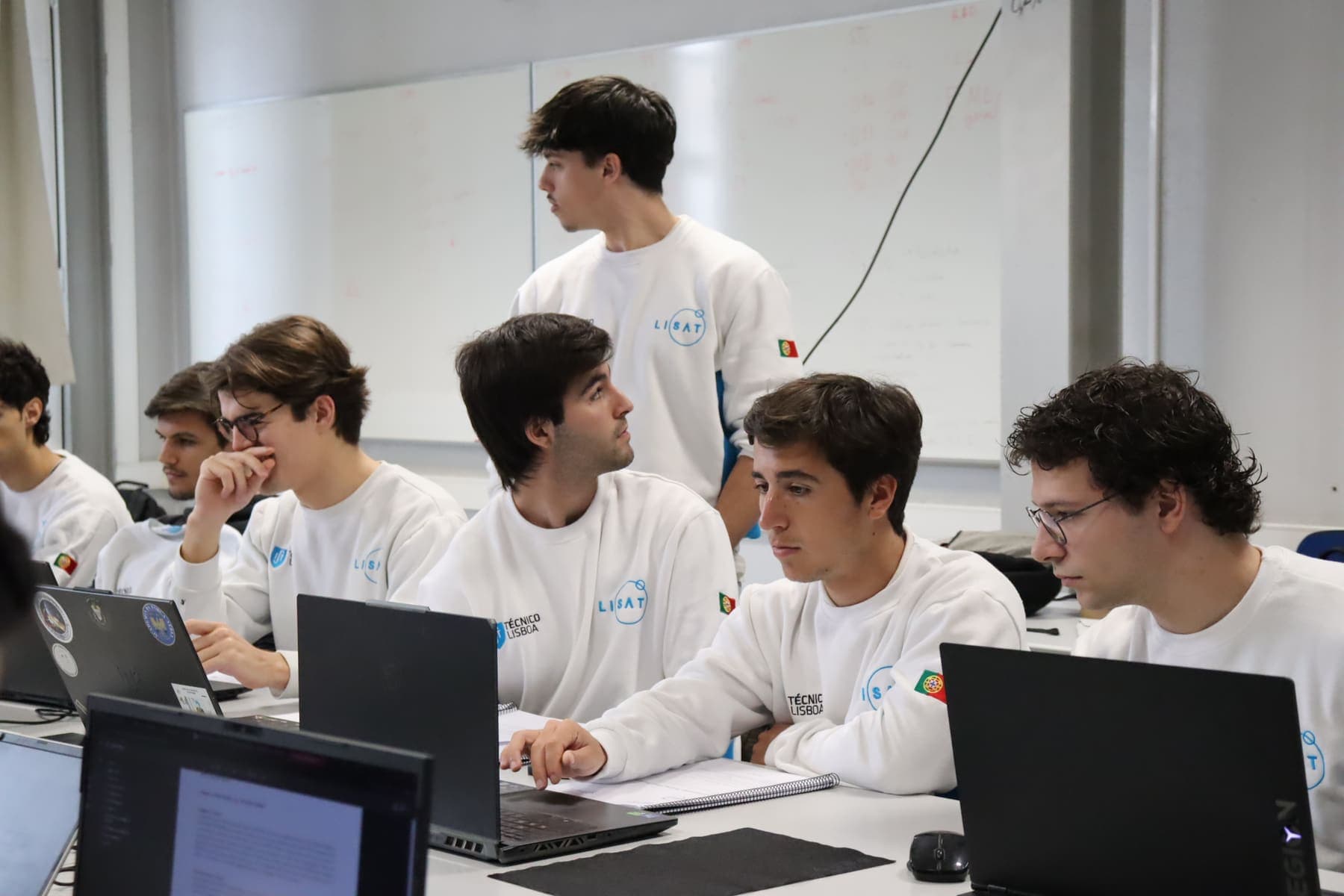 Team members at their laptops during the review